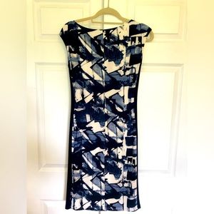 Lauren navy blue and cream dress, asymmetrical shirting at waist.
